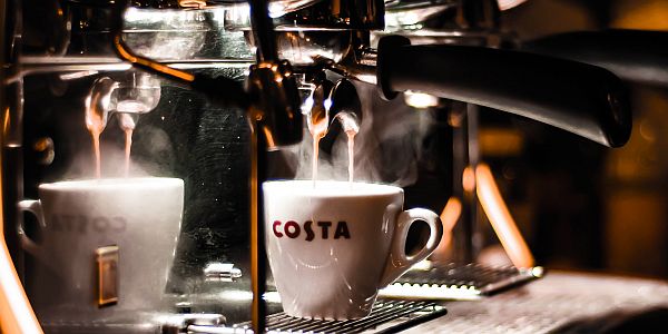 Coffee from a coffee machine running into a cup