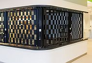 a black sliding shutter wrapping around a corner