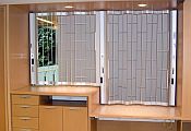 Classic chainlink sliding shutter with a higher and lower section