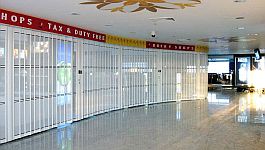 Long set of sliding folding security shutters closing off a duty-free shop at Alexandria International Airport