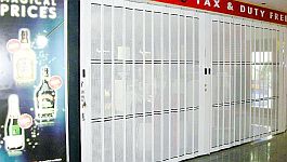 Detail of a white sliding shutter with small perforations