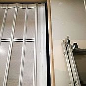 Detail of where the sliding shutter securely locks against the wall