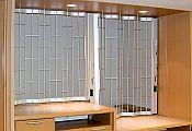 Sideview of a Classic chainlink sliding shutter with a higher and lower section