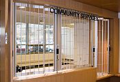A reception area with a high and low section, closed off by security shutters