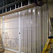 Sliding security shutter closed and locked in front of a shop-entrance