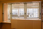 A classic chainlink sliding shutter on a reception desk with a high and low section