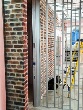 Part of a FlexiGlide Visiosn Guard sliding shutter with an anodised natural finish.