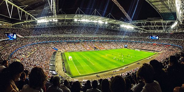 audience in a large football stadium in the evening