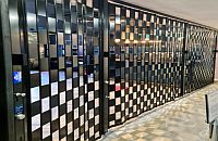 Powdercoated black FlexiGlide sliding shutter of the Barrier type