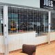 Coffee bar secured by FlexiGlide classic chainlink sliding grille.