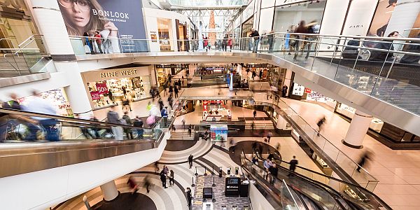 people on escalators in a large shopping centre