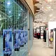 A curved FlexiGlide chainlink classic sliding shutter in a shopping mall