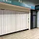 White Protector sliding shutter from FlexiGlide across the entrance to a coffee room