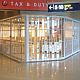 A long Vision Glass security shutter protecting an angled shop-front in an airport duty-free area.
