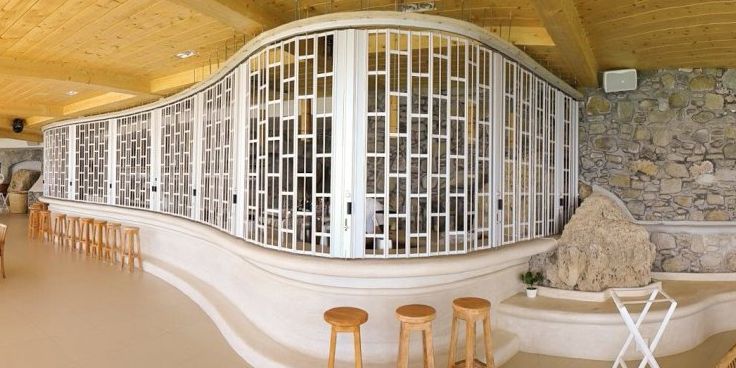 A sliding folding shutter at a curved bar