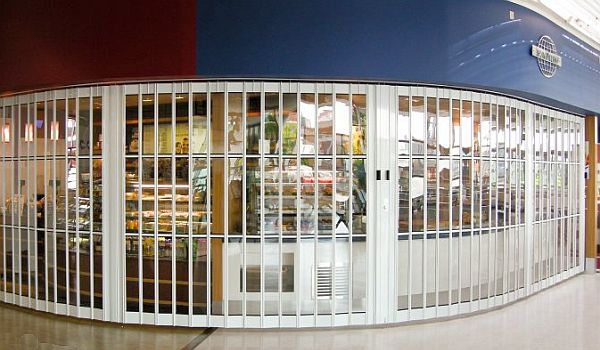 Sliding shutters can be made for openings in straight lines... or to follow a curved line Sliding shutter covering a curved opening