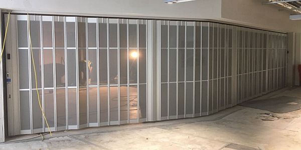 A sliding folding security shutter installation with angled corners